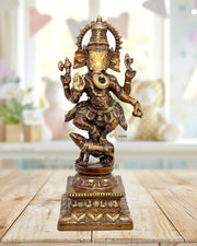 Bronze statue of a deity on a wooden surface with a blurred background