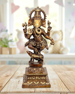 Bronze statue of a deity on a wooden surface with a blurred background