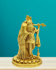 Gold statue of a deity against a teal background