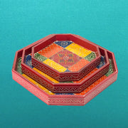 A set of three hand-painted wooden serving trays with octagonal shape, featuring vibrant colors and traditional Indian patterns.