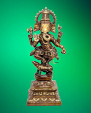 Bronze statue of a deity on a green background