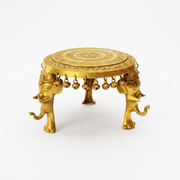 handmade solid brass round pooja chowki Ras Al Khaimah, artisan engraved brass pooja stand Fujairah, intricate hand engraved brass chowki Umm Al Quwain, brass round chowki with hanging bells Al Ain, 