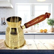 Luxury coffee warmer with jali grip
Brass coffee maker with wood handle
UAE handcrafted Arabic coffee pot
Al Athar brass coffee pot with jali