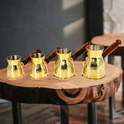 brass turkish coffee maker with hammerwork
turkish coffee pot with wooden handle
handcrafted brass cezve with jali handle
traditional turkish coffee brewing pot
vintage-style turkish coffee maker
arabic gahwa pot in brass
hotelware turkish coffee pot
metal coffee maker with wooden grip
artisan turkish cezve for home brewing
small brass pot for rich coffee