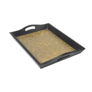 A set of three wooden serving trays with brass fittings, stacked on top of each other, with the top tray containing a small amount of spilled granular substance.