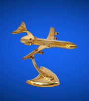 Gold airplane model on a blue background